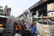 PATNA, MAY 4 (UNI):- Firefighters dousing a fire which broke out in the slums, near Chitkohra area, in Patna on Saturday. UNI PHOTO-94U